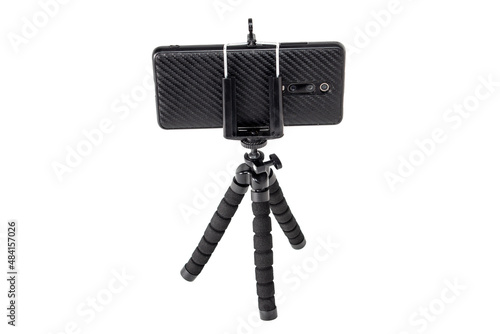 Black tripod for with installed smartphone. Isolation on white.