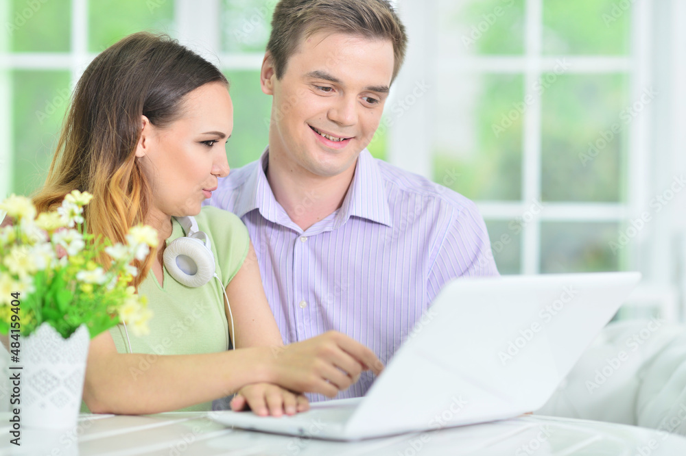 Portrait of young couple with laptop at home Portrait of young couple with laptop at home