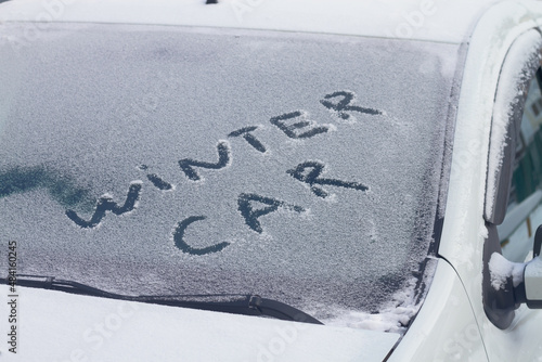 White car in winter with the inscription on the windshield on the snow winter car