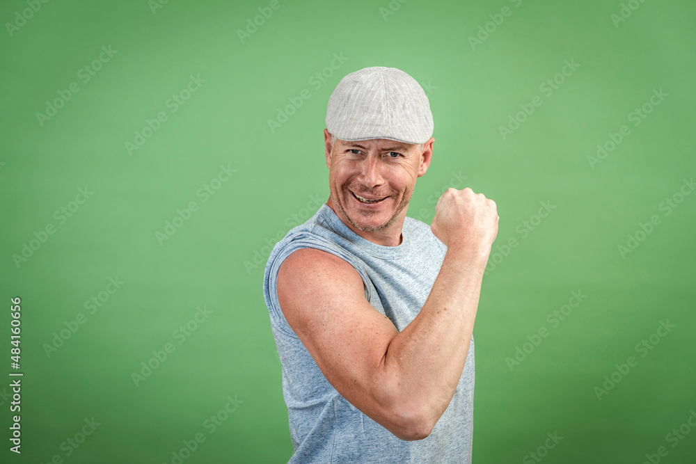 frenchman with gray cap and gray shirt against green background frenchman with gray cap and gray shirt against green background