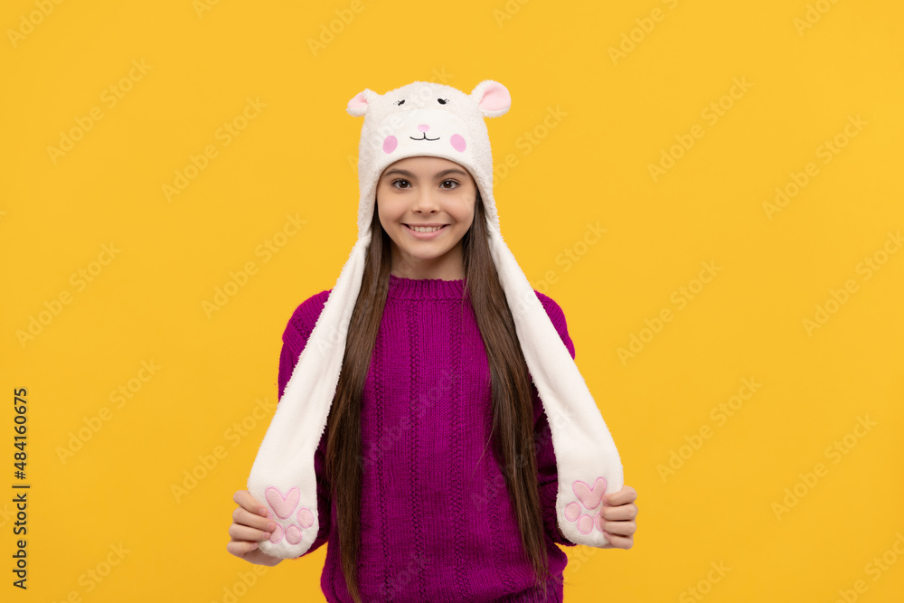 teen girl in knitwear. express positive emotion. positive child in earflap hat.