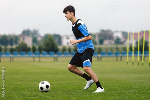 Young Footballer Running Ball During Soccer Training Unit. Football Education for Youths