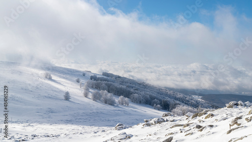 Distant fog covering the forests seen from the top of the mountain © Byby Photography