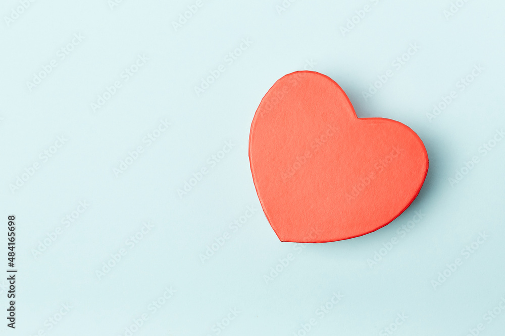 Gift heart shape red box with little hearts inside on blue background. Top view, gift card. Gift heart shape red box with little hearts inside on blue background. Top view, gift card.