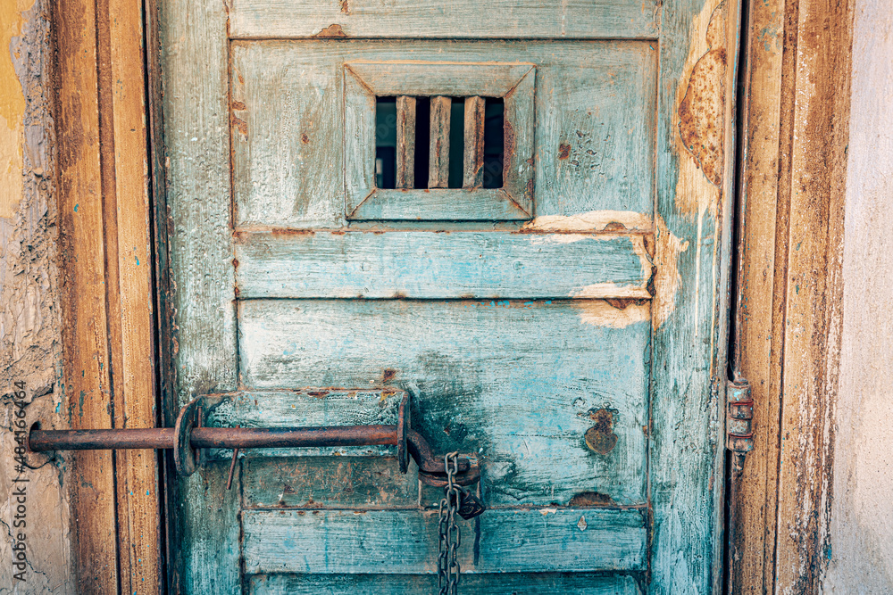 Scary and rusty grunge door to the detention cell in old prison. The concept of fear of conviction and penitentiary system. Scary and rusty grunge door to the detention cell in old prison. The concept of fear of conviction and penitentiary system.