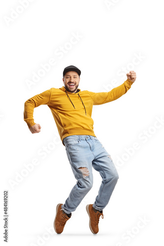 Full length portrait of a cheerful young casual man dancing