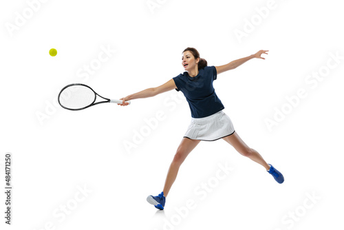 Dynamic portrait of young sportive woman, tennis player practicing isolated on white background. Healthy lifestyle, fitness, sport, exercise concept. © master1305