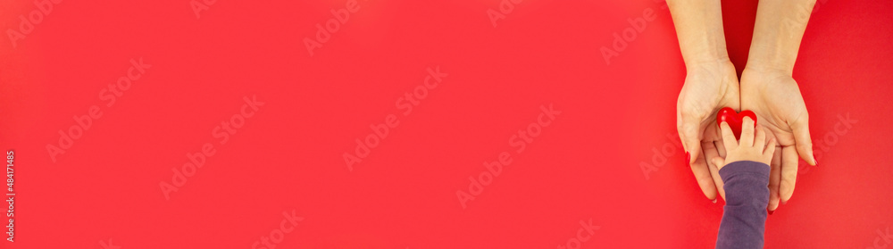 valentine. heart in hands on a red background. valentine. heart in hands on a red background.