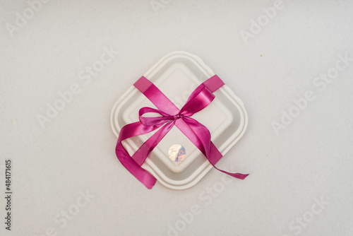 Bento Cake. Portioned trandy dessert for one person in eco box with purple ribbon, small cake. Pink ribbon.