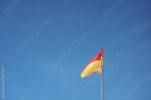 A red over yellow flag at beach signifies a recommended swimming area that has lifeguard supervision. 