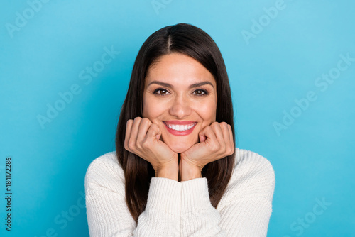 Photo of lovely young lady hands face wear white pullover isolated on blue color background