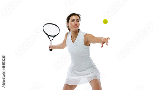 Portrait of young sportive woman, tennis player playing tennis isolated on white background. Healthy lifestyle, fitness, sport, exercise concept. © master1305