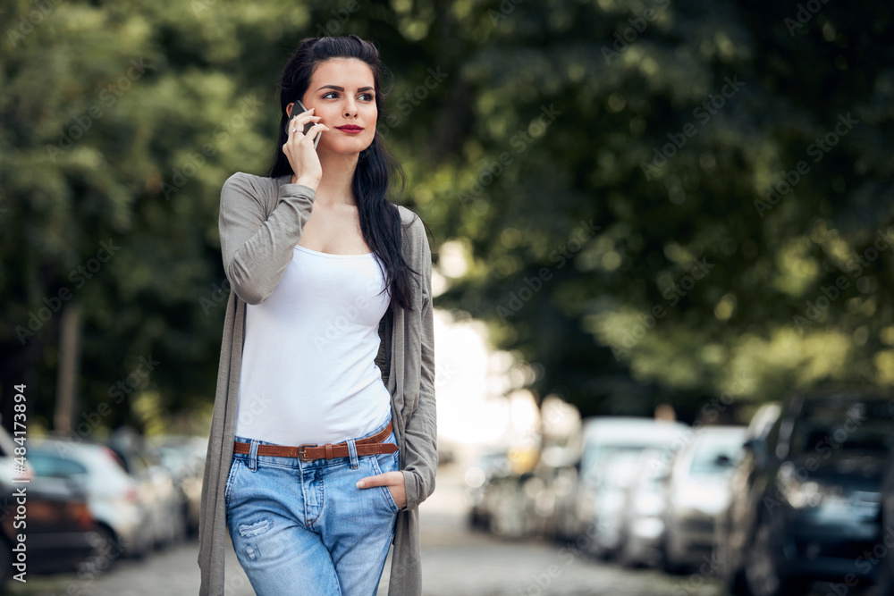 Young cute female using smartphone on the street. Young cute female using smartphone on the street.