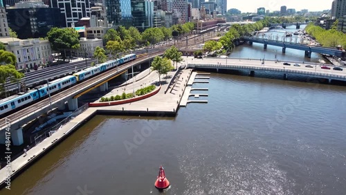 Aerial drone shot of train entering Flinder's Street Station Melbourne CBD City Yarra River Victoria Australia 4K photo