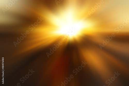 Abstract blurred golden background with a flash and diverging rays in the middle