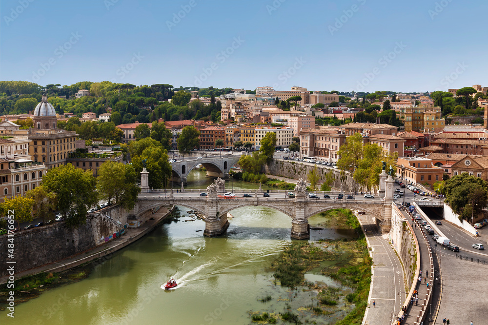 Top view of Rome with the Victor Emmanuel II bridge across the Tiber and city blocks. Italy