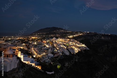 Panoramic view of the picturesque illuminated village of Fira Santorini Greece at night time © DIMITRIOS