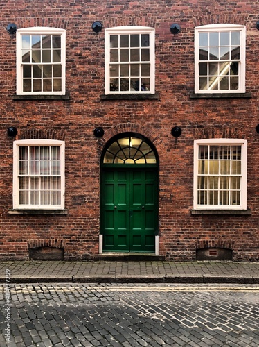 Photography old Victorian brick townhouse building with sash windows