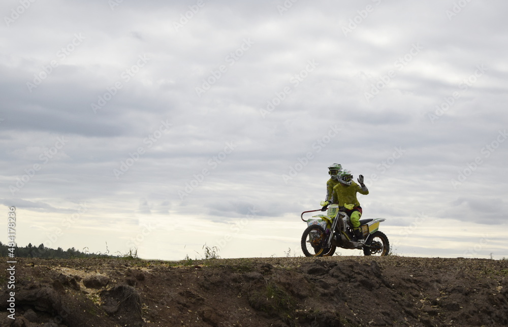 motocross bikers on motorcycles with carrycot motocross bikers on motorcycles with carrycot