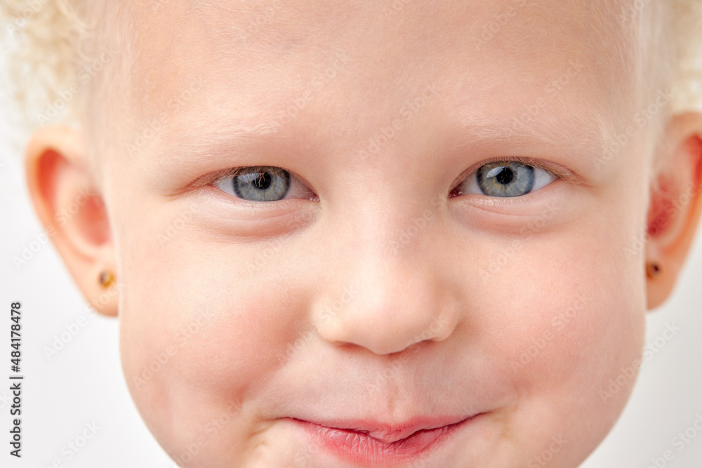 close-up portrait of healthy caucasian child girl looking at camera, shy and diligent, blue eyes blonde kid girl isolated over white studio background. children, natural beauty concept close-up portrait of healthy caucasian child girl looking at camera, shy and diligent, blue eyes blonde kid girl isolated over white studio background. children, natural beauty concept
