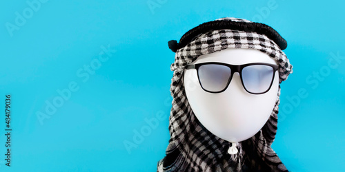 Balloon traveler in sunglasses and arafat concept tourist in Dubai or Egypt photo