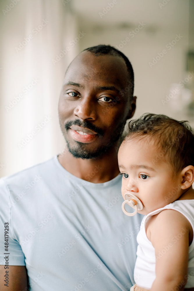 Portrait of father carrying son at home Portrait of father carrying son at home