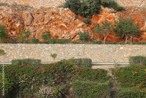 mountain road on a rocky slope in Alanya, beautiful ornamental plants, Turkey. photo