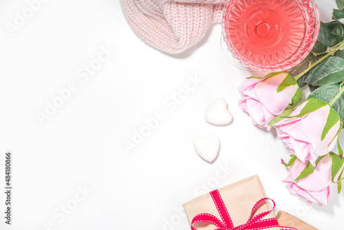 Valentines day, march 8, mother day greeting card background. Pink rose flower bouquet, craft gift box with red ribbon, rose wine cocktail on white table background copy space © ricka_kinamoto