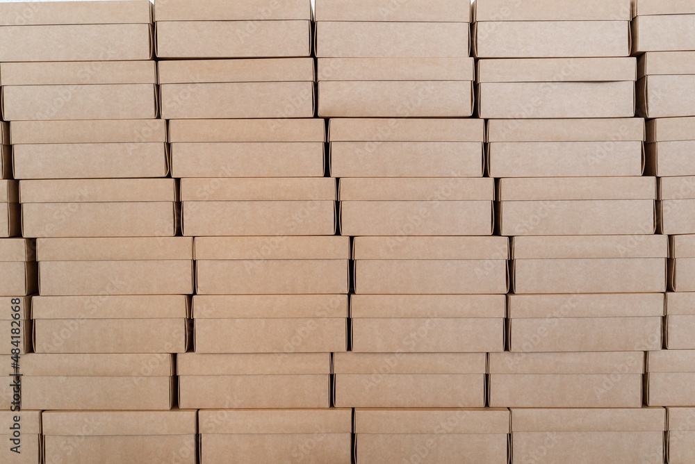 Fototapeta premium Wall made of closed cardboard boxes stacked in pattern