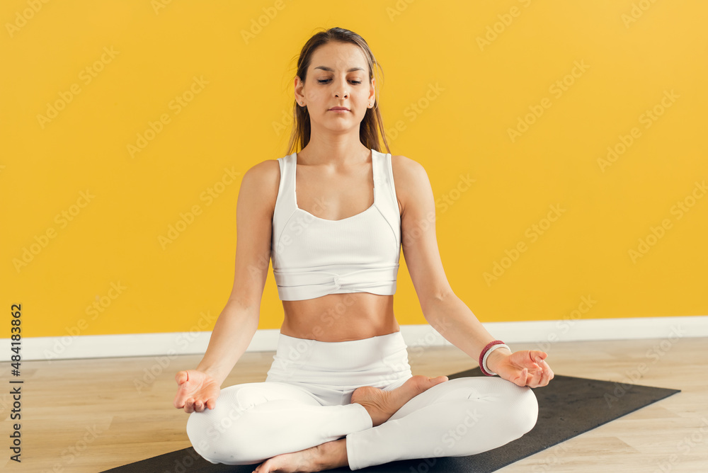 Yogi woman practicing yoga lesson, meditating, doing Lotus pose with mudra gesture, close up. Well being, wellness concept