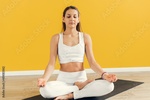 Yogi woman practicing yoga lesson, meditating, doing Lotus pose with mudra gesture, close up. Well being, wellness concept