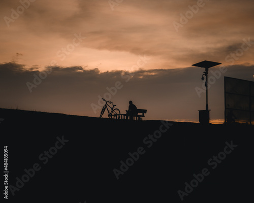 man and bicycle at sunset 