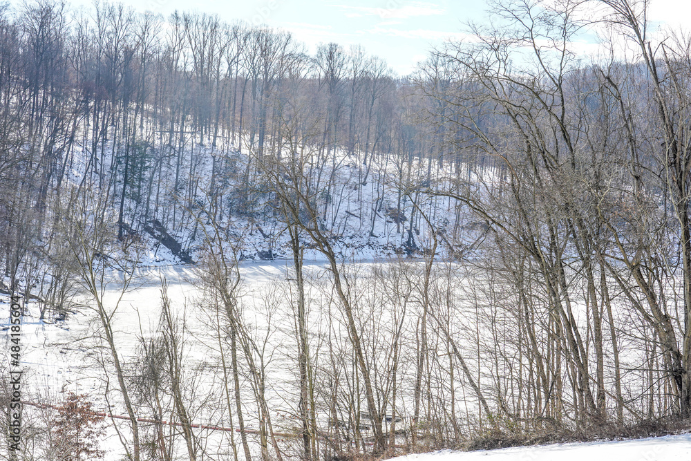 Partially frozen water at the Loyalhanna reservoir located in Western Pennsylvania. Riverbank, trees, ice. Partially frozen water at the Loyalhanna reservoir located in Western Pennsylvania. Riverbank, trees, ice.