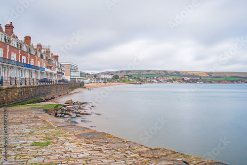 A long exposure image of Swanage seafront and the still pale blue sea photo