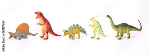 Various dinosaurs from prehistoric times in a row on white background.