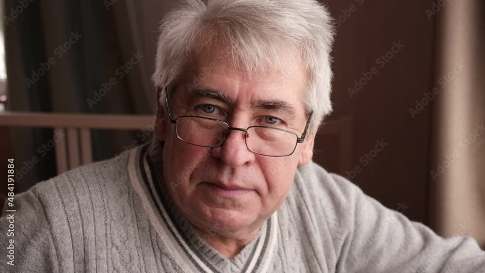 Close-up portrait of happy senior man looking at camera. Senior grey-haired man. Retired elderly man sitting at home near window. Positive and confident elderly enjoy his retirement.
Close-up portrait of happy senior man looking at camera. Senior grey-haired man. Retired elderly man sitting at home near window. Positive and confident elderly enjoy his retirement.