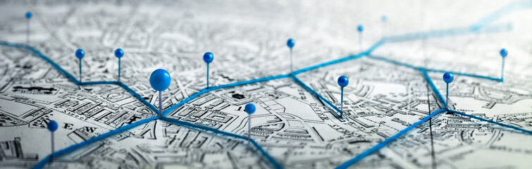 Routes with blue pins on a city map. Concept on the  adventure, discovery, navigation, communication, logistics, geography, transport and travel topics.