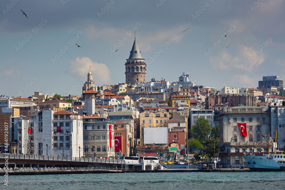 Cityscape with sea and houses on the shore, old tower and sights. Golden Horn Bay, Galata Tower. Istanbul, Turkey. Journey, sights