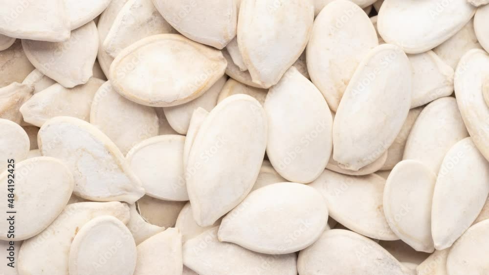 Closeup top view of pumpkin seeds. Food backdrop Closeup top view of pumpkin seeds. Food backdrop