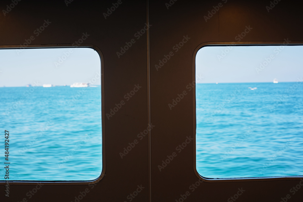 Blue sea in the windows of the ship. The sea in a black frame. Travel to Istanbul, Turkey.