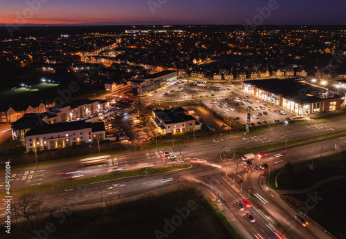 Busy streets with light trails in and around commercial outlets in the UK. Night photgraphy with energy. photo