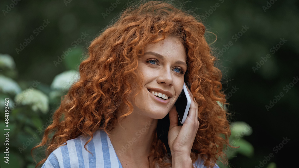 glad young woman with red hair talking on smartphone. glad young woman with red hair talking on smartphone.