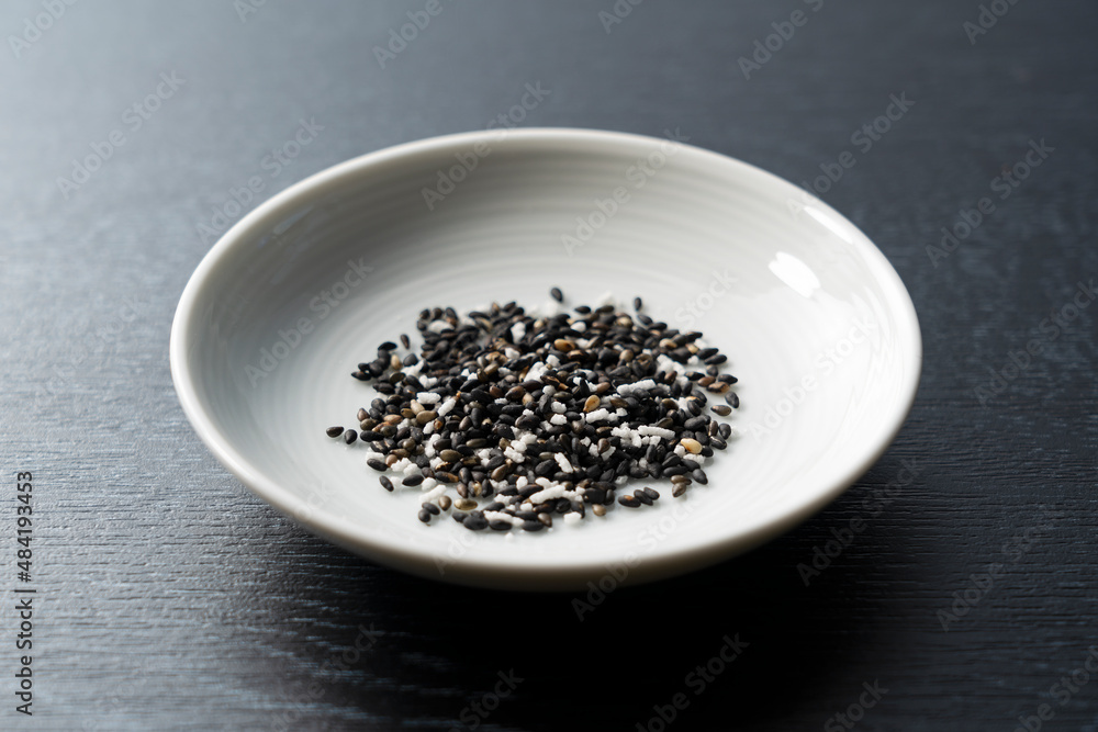 Sesame salt placed on a black background. Sesame salt placed on a black background.