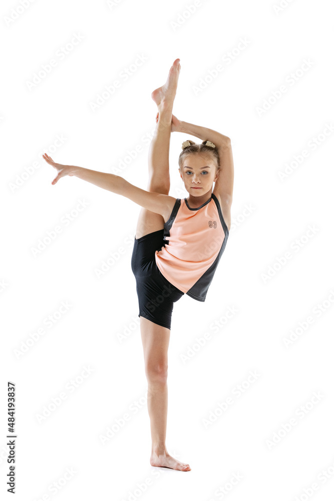 Little flexible girl, rhythmic gymnastics artist isolated on white studio background. Grace in motion, action. Doing exercises in flexibility. Little flexible girl, rhythmic gymnastics artist isolated on white studio background. Grace in motion, action. Doing exercises in flexibility.
