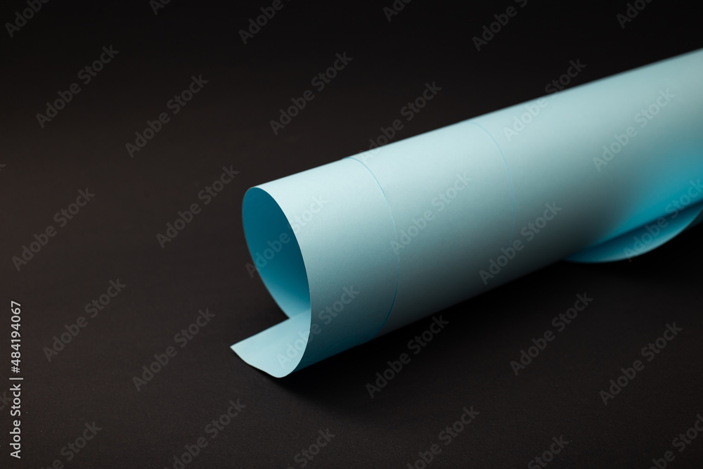 Bright paper rolled up against the background Bright paper rolled up against the background
