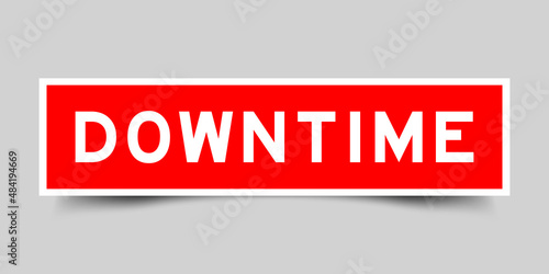 Sticker label with word downtime in red color on gray background