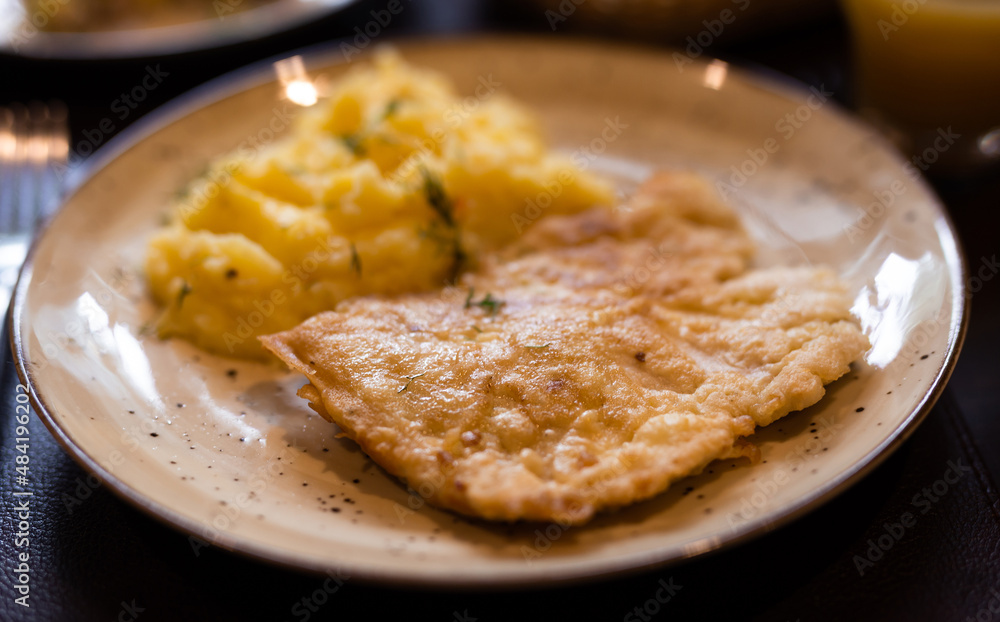 Appetizing chicken breasts in batter with mashed potatoes on plate Appetizing chicken breasts in batter with mashed potatoes on plate
