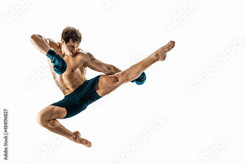 Full size of athlete boxer who perform muay thai martial arts on white background. Blue sportswear 