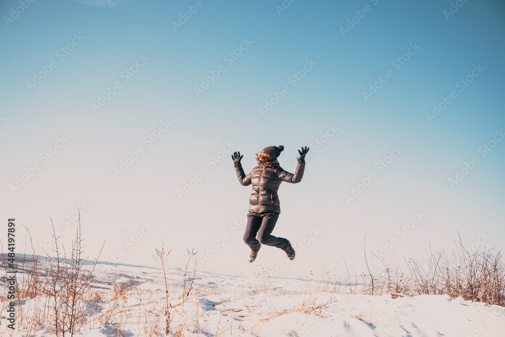 happy woman jumping outdoors in winter mindfulness happy woman jumping outdoors in winter mindfulness