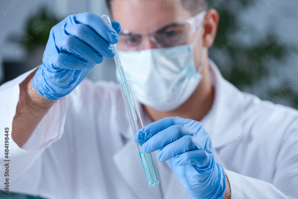 Scientist working with sample in chemical laboratory, focus on hands Scientist working with sample in chemical laboratory, focus on hands
